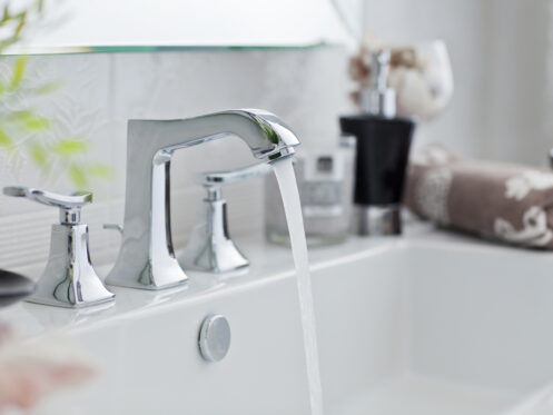 Clean water flowing from a bathroom faucet