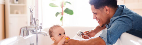 Dad giving son a bath