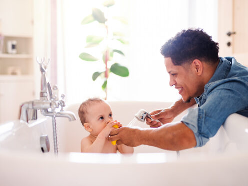Dad giving son a bath