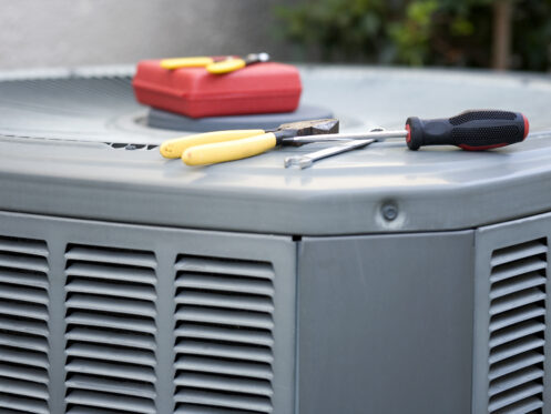 tools on air conditioner condenser residential unit