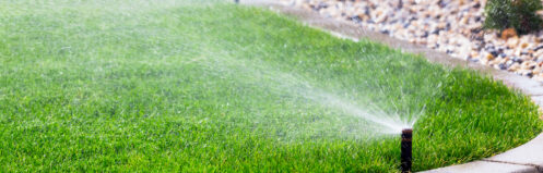 Sprinkler system watering a lawn in Williams Lake