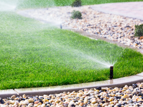 Sprinkler system watering a lawn in Williams Lake